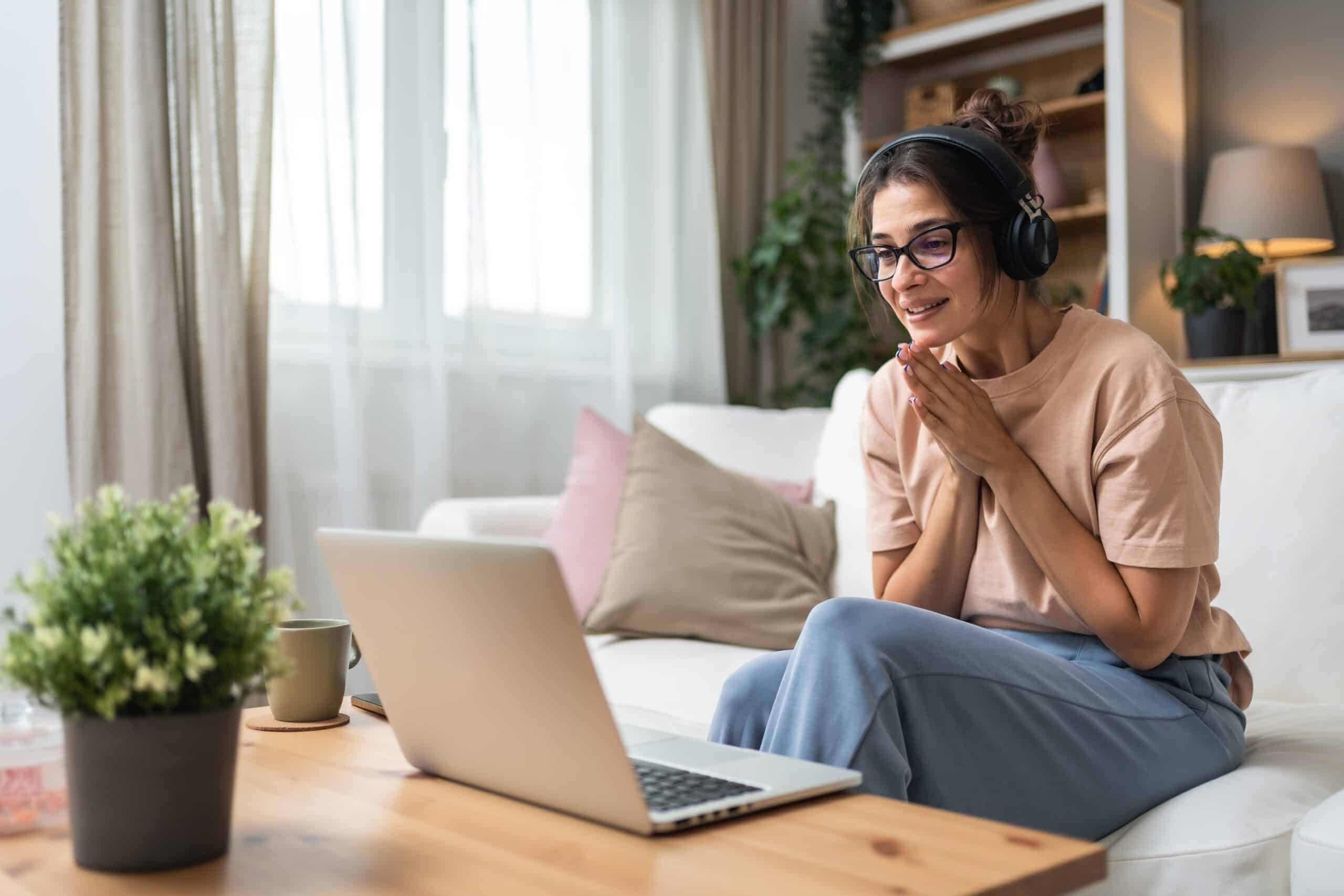 Midlife woman participating in online counseling session from home, focused on managing stress, anxiety, and life transitions.